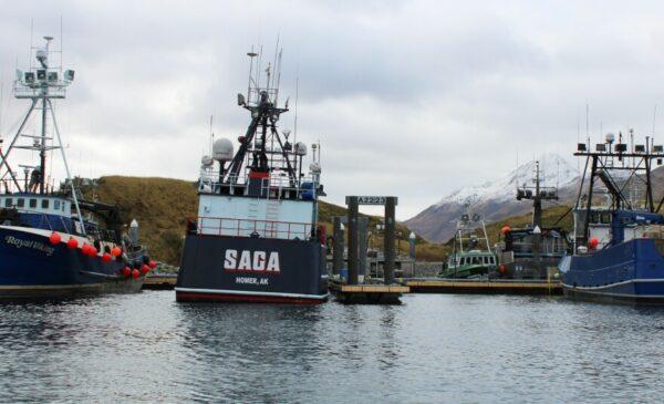 A large boat in a harbor in front of some treeless hills